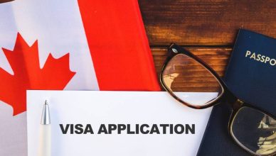 Flag of Canada and Canada visa application kept upon a table,