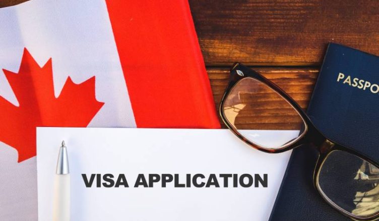 Flag of Canada and Canada visa application kept upon a table,