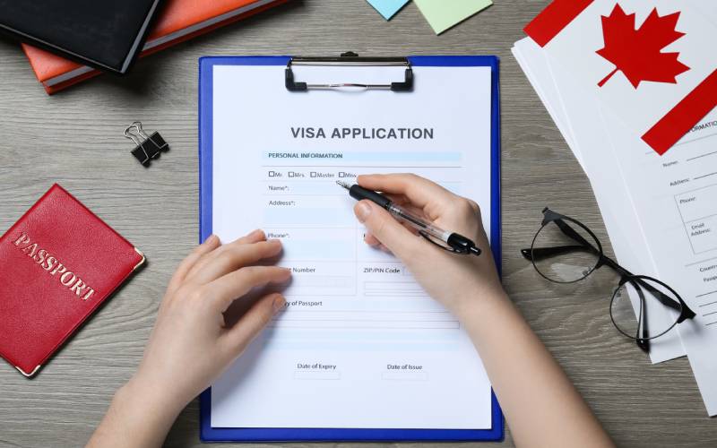 Woman filling Canada visa application form